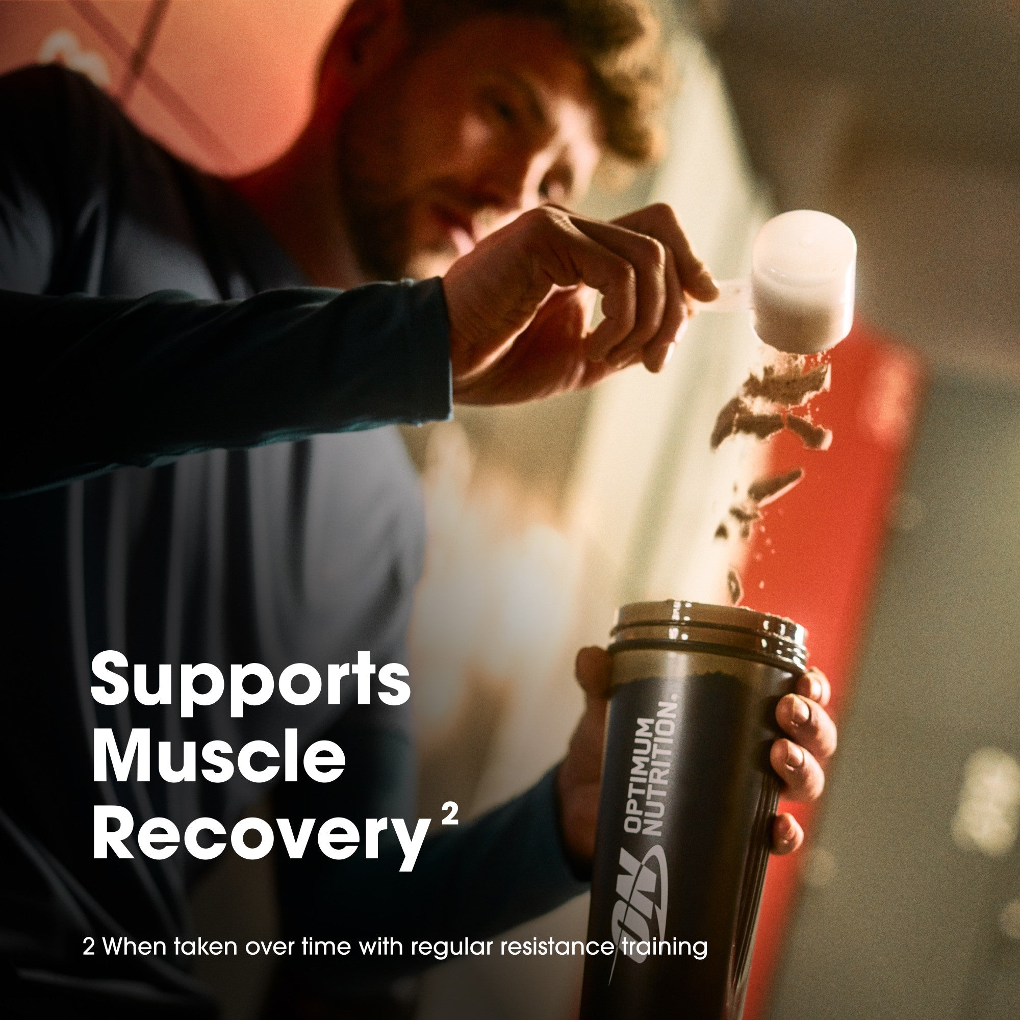 Person holding a shaker bottle with Optimum Nutrition branding, text about muscle recovery.