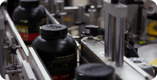 ON whey protein bottles on an assembly line